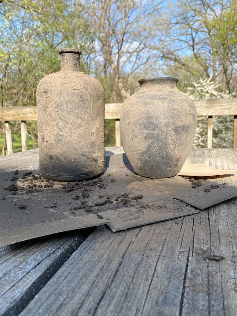 The difference between the vase I had removed some of the dirt and the one that had not yet had any removed. One is much smoother and lighter.