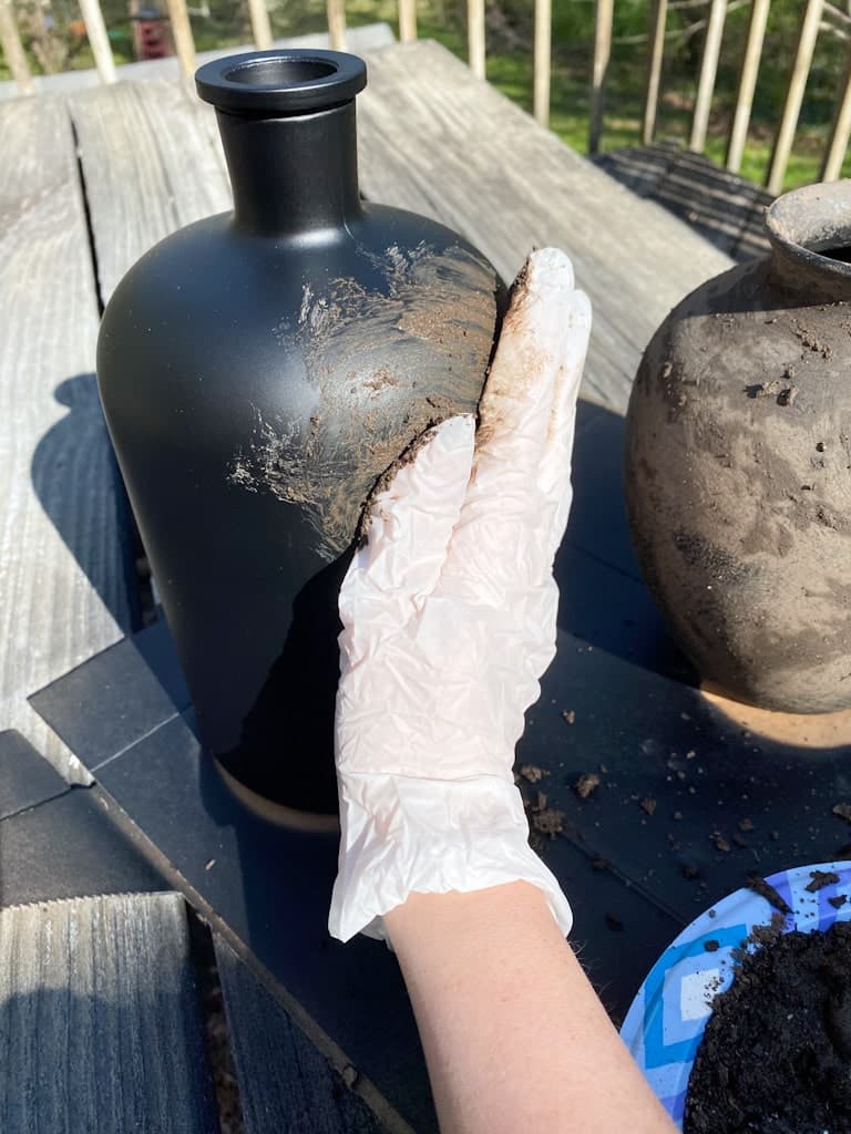 Using a glove I rubbed the mud onto my upcycled vases.