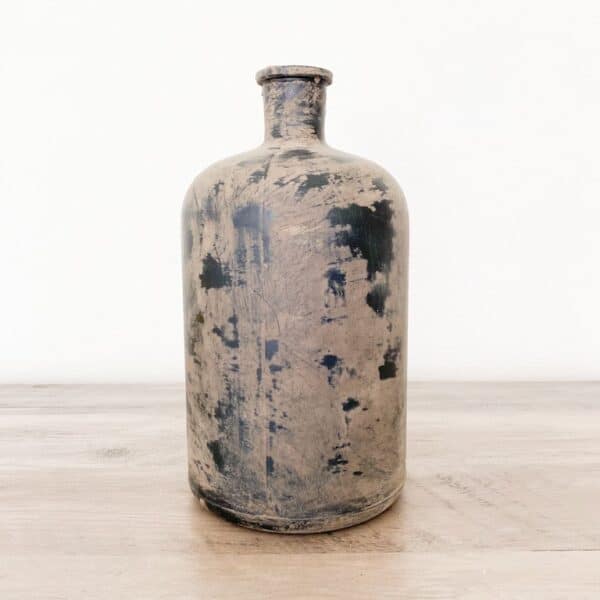 Black vase with mud distressing.