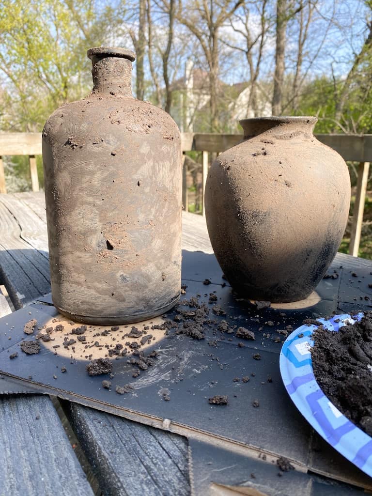 How the 2 upcycled vases looked after rubbing the mud all over them.