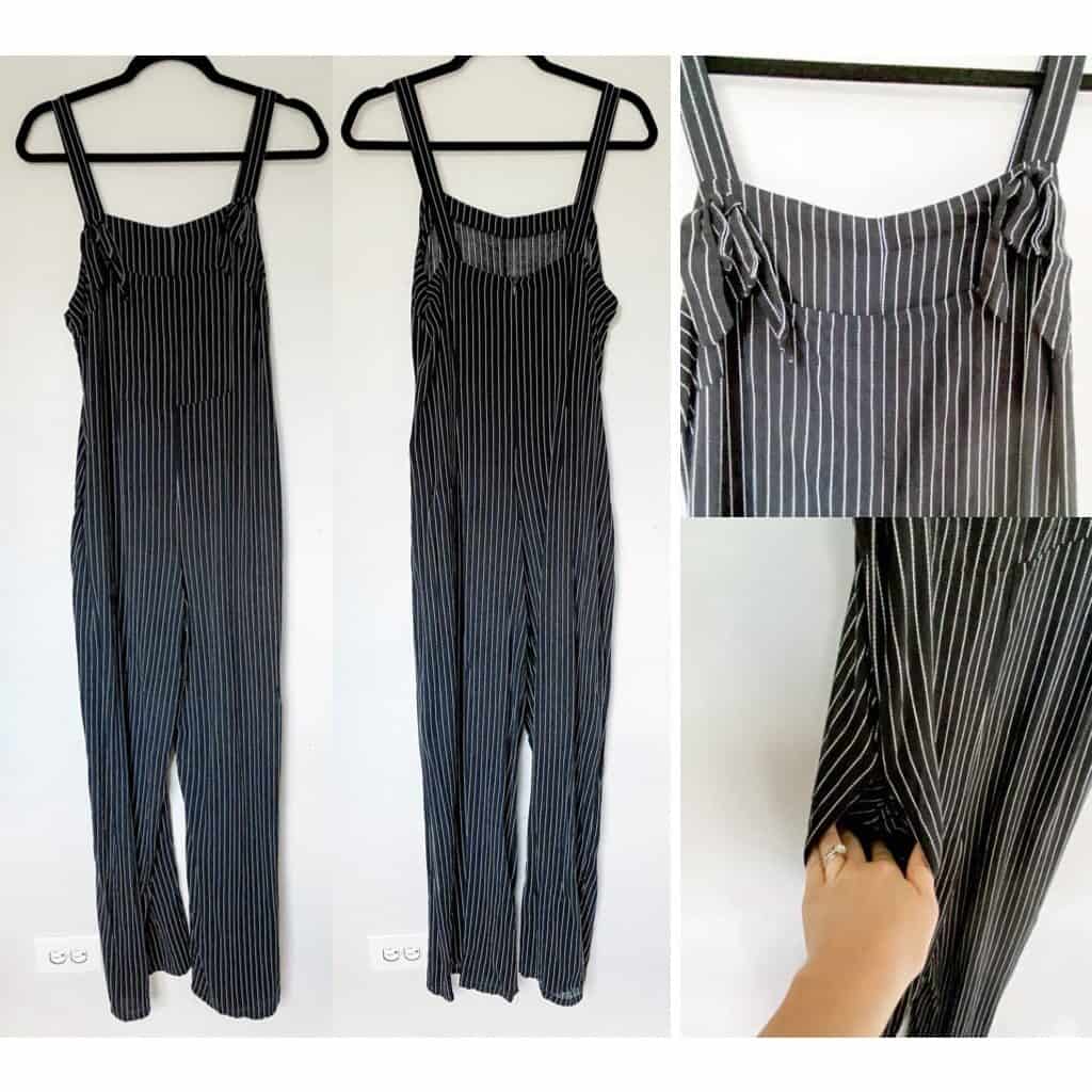 Overalls that are black with a thin white pin stripe, the straps loop through a hole in the front on either side and are tied in a knot to secure.