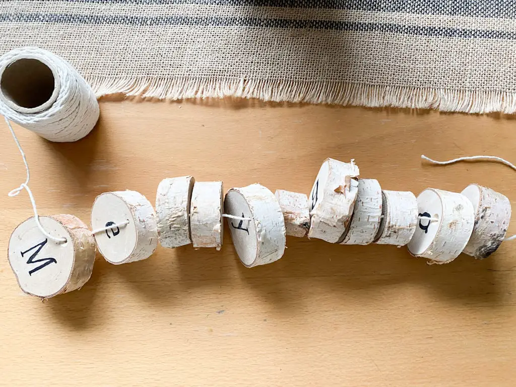 all slices of wood strung onto a cream string.