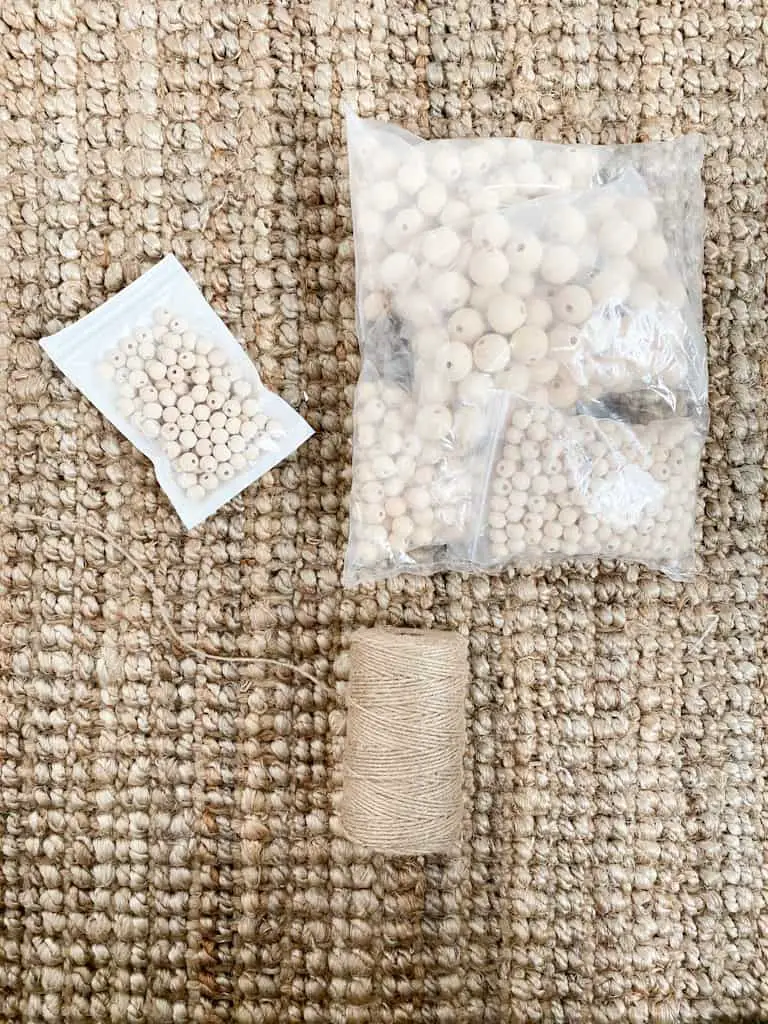 The supplies you will need for one of your DIY Christmas mantle garlands are assorted sized wood beads and twine.