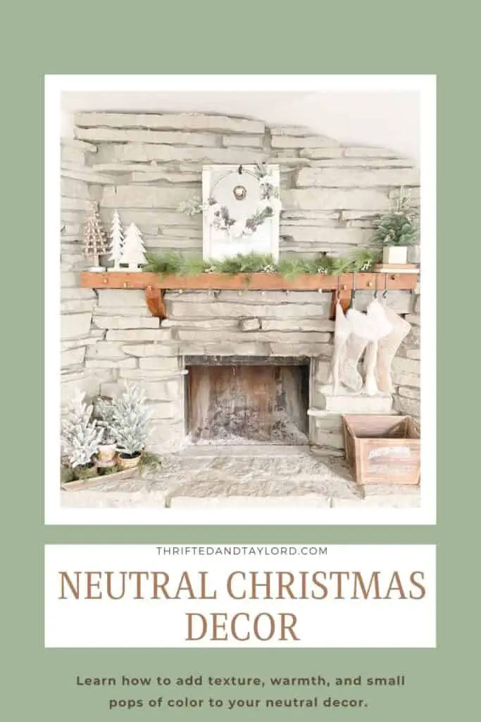 Image shows a fireplace with neutral Christmas decorations.