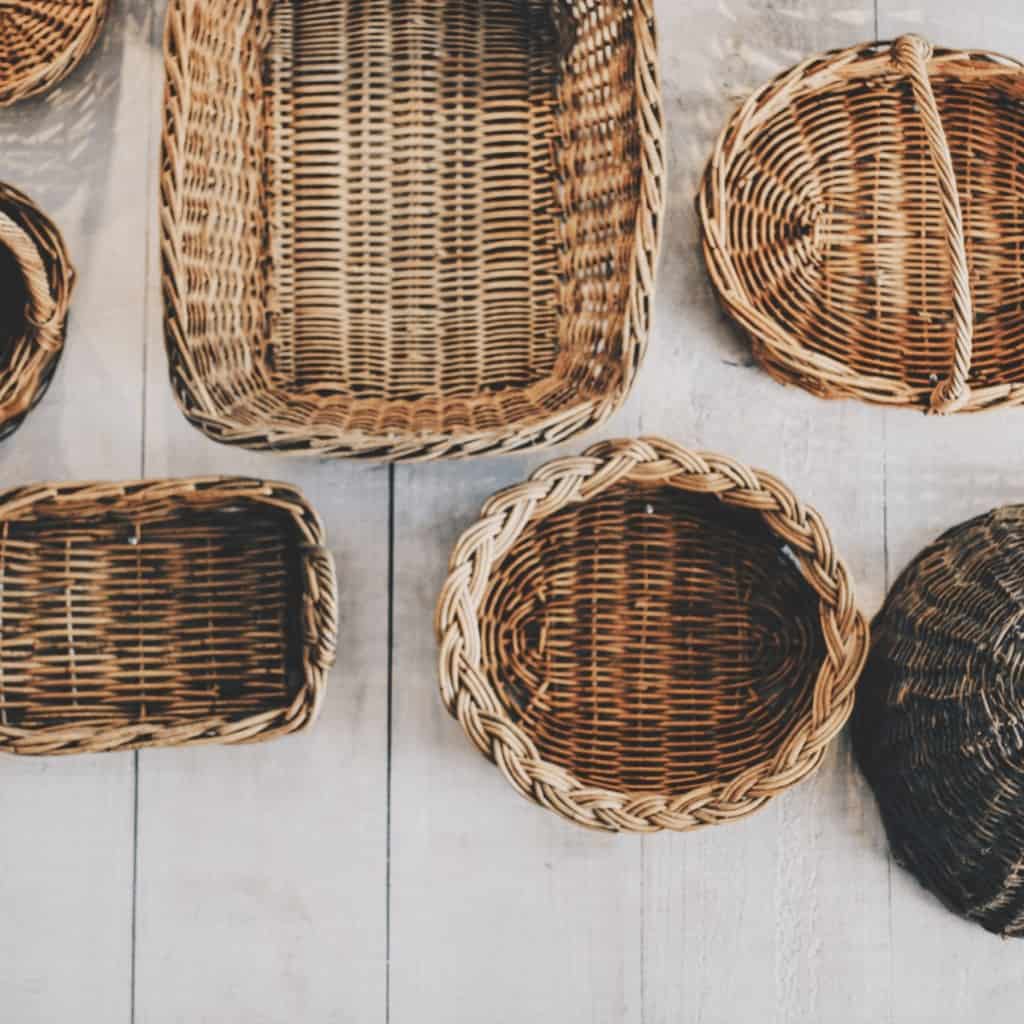 Image shows several different sizes and shapes of wicker baskets.