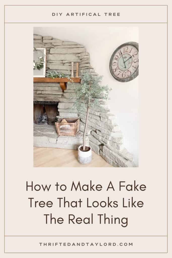 Check out how to make a fake tree for your own home that looks super realistic. Photo shows an artificial potted tree in front of a stone fireplace with a wooden box on the ledge. There is a clock on the wall, and on the fireplace mantel there is a window mirror with a spring hoop wreath on it, a garland, and 2 wooden antique looking candle holders.