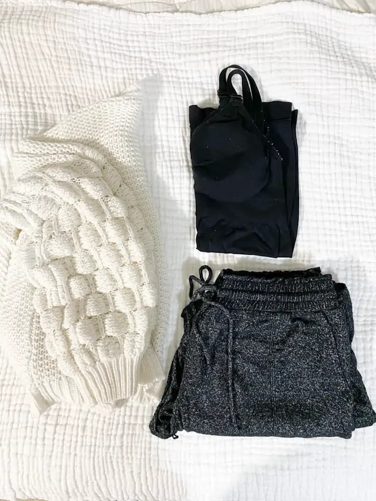 This is what's in my hospital bag for mom. a white cardiagn, a black nursing tank top, and some gray high rise pajama pants t wear in the hospital.