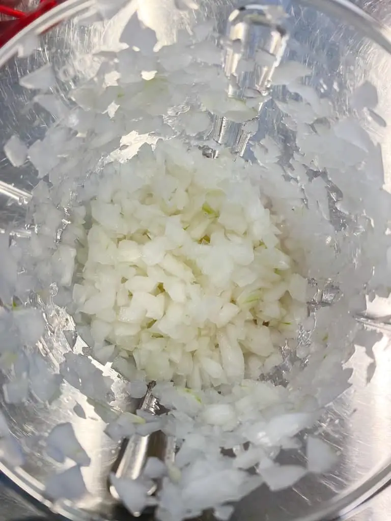 Finely diced white onions in the Supersonic Chopper from Tupperware.