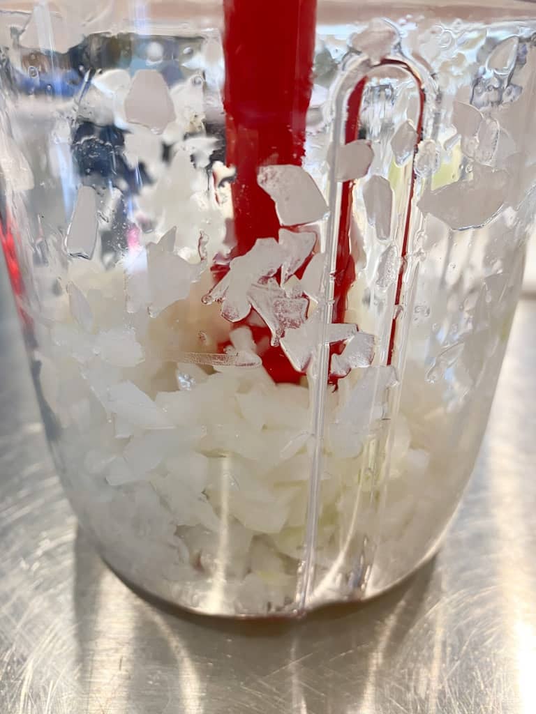 Coarsely chopped white onions in the Supersonic Chopper from Tupperware.