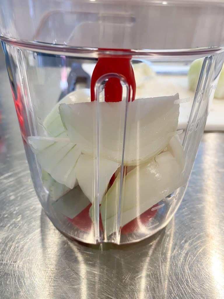 Large chunks of white onion in thee Supersonic Chopper from Tupperware.